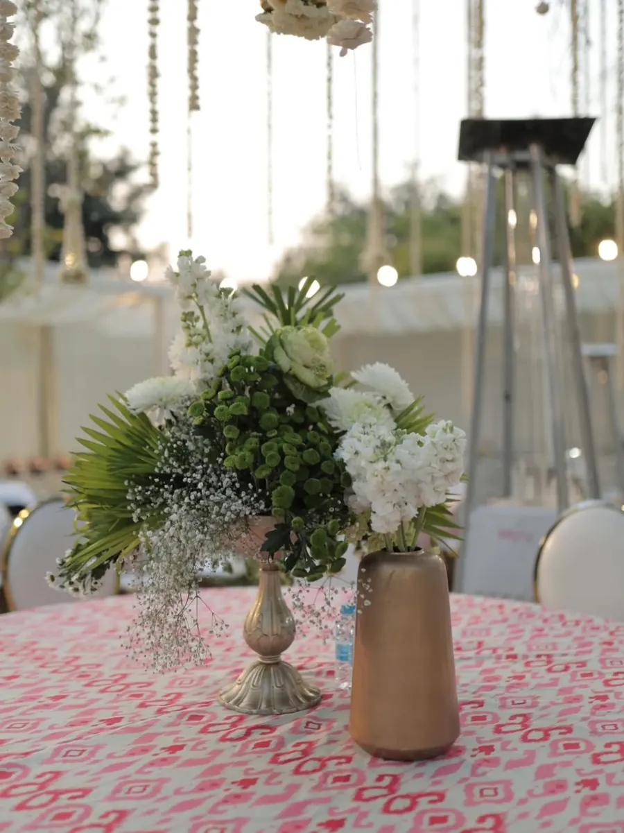 Close-up of a white and green centrepiece on block-printed linen