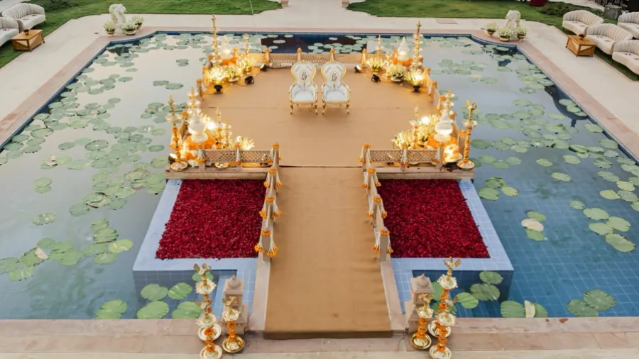Mandap on a lily pond, approached by red carpeted walkways