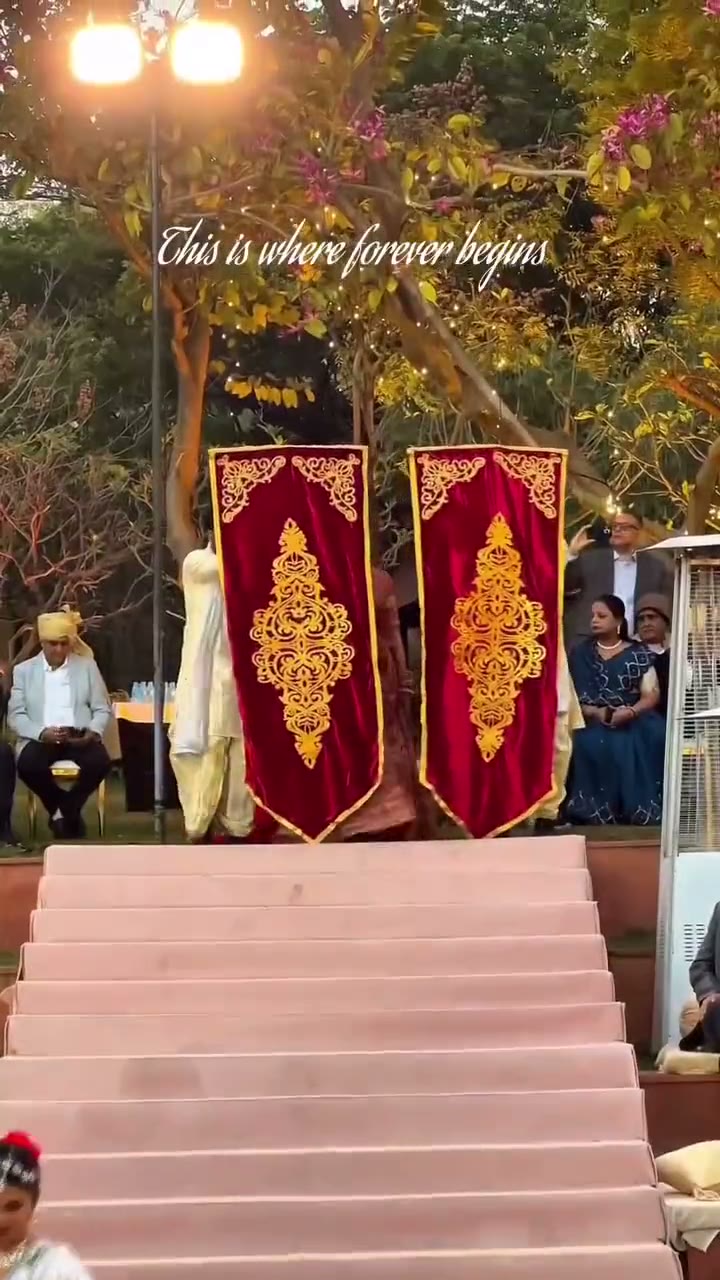 Red and gold reception stage with a staircase and drapes